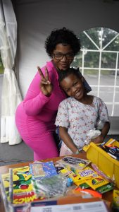 A mother and daughter receive school supplies at a school giveaway supported by Good360.