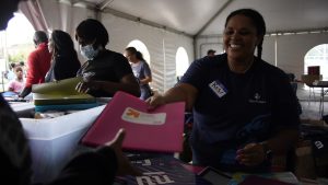 A nonprofit volunteer hands out donations. 