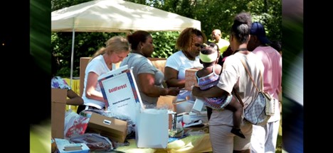 Volunteers hand out donated products from Amazon.