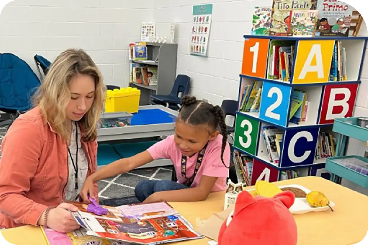 A volunteer reads to a child.